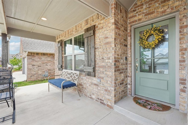 8400 Poplar Dr, Edmond, OK 73034 - entrance to property featuring a porch and brick siding