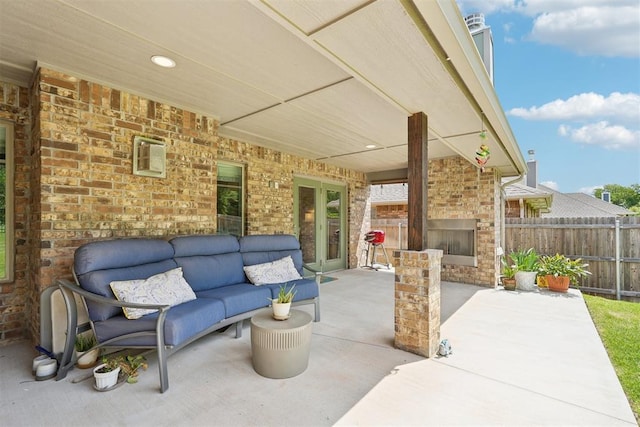 8400 Poplar Dr, Edmond, OK 73034 - view of patio / terrace with an outdoor living space with a fireplace and french doors