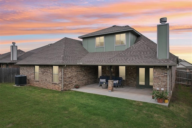 8400 Poplar Dr, Edmond, OK 73034 - back of house featuring a chimney, roof with shingles, a patio, and brick siding