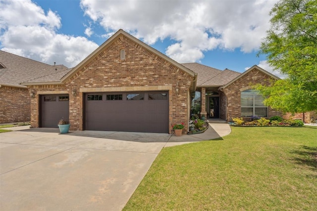 12812 NW 6th St, Yukon, OK 73099 - view of front of home with a garage, brick siding, driveway, and a front lawn