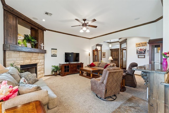 12812 NW 6th St, Yukon, OK 73099 - living area featuring arched walkways, ceiling fan, crown molding, a fireplace, and carpet flooring