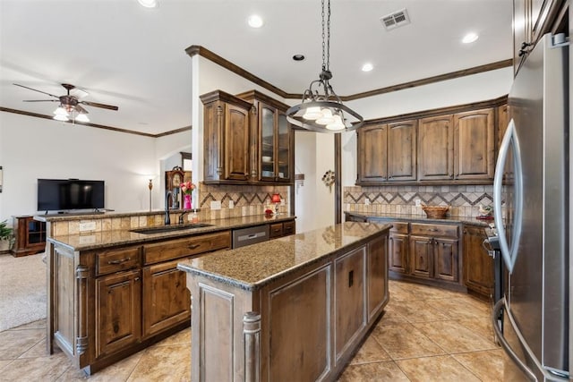 12812 NW 6th St, Yukon, OK 73099 - kitchen with a sink, stainless steel appliances, a center island, crown molding, and ceiling fan