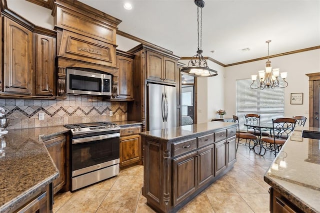 12812 NW 6th St, Yukon, OK 73099 - kitchen with stainless steel appliances, ornamental molding, backsplash, dark stone countertops, and pendant lighting