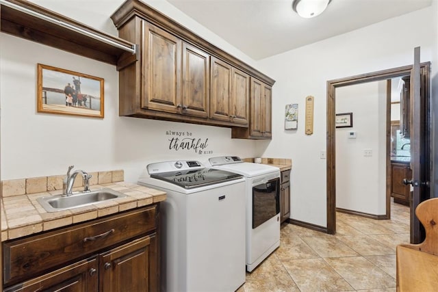 12812 NW 6th St, Yukon, OK 73099 - laundry area with cabinet space, washer and clothes dryer, and light tile patterned flooring