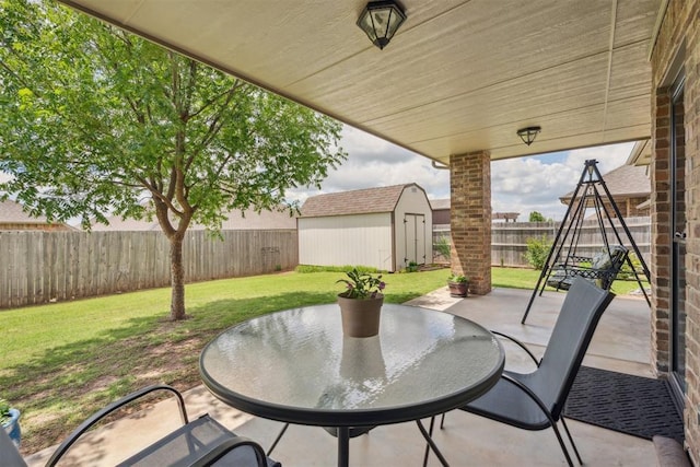 12812 NW 6th St, Yukon, OK 73099 - view of patio / terrace featuring a storage unit and an outbuilding