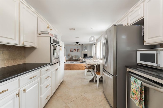 2728 Kerry Ln, Oklahoma City, OK 73120 - kitchen with stainless steel appliances, open floor plan, beverage cooler, ceiling fan, and white cabinetry