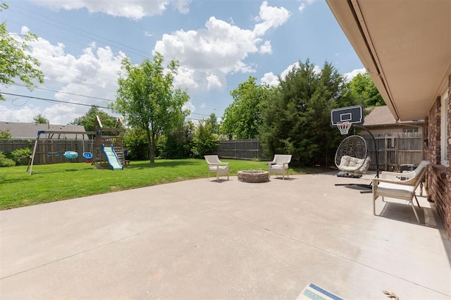 2728 Kerry Ln, Oklahoma City, OK 73120 - fenced backyard featuring an outdoor fire pit, a playground, and a patio