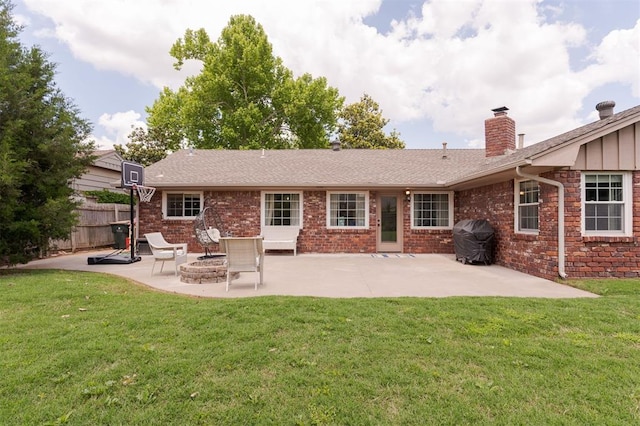 2728 Kerry Ln, Oklahoma City, OK 73120 - back of property featuring a patio, an outdoor fire pit, a chimney, and brick siding