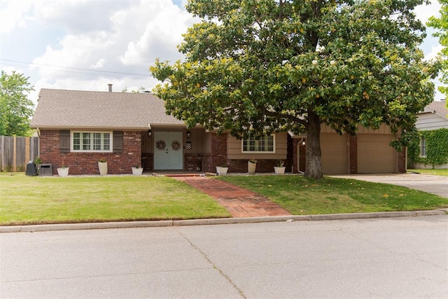 2728 Kerry Ln, Oklahoma City, OK 73120 - view of front of house with brick siding, driveway, and a garage