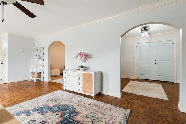 2728 Kerry Ln, Oklahoma City, OK 73120 - foyer featuring arched walkways, ceiling fan, and crown molding