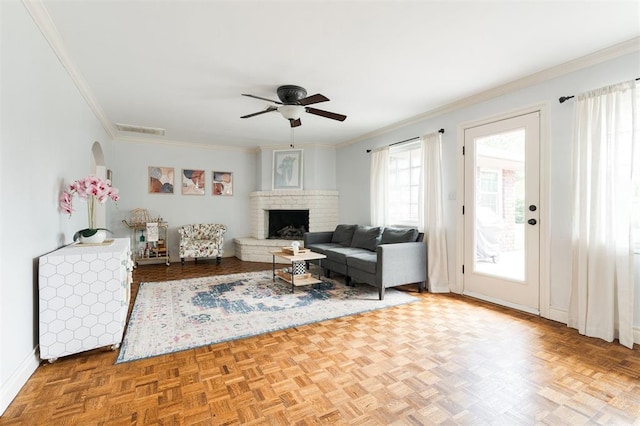 2728 Kerry Ln, Oklahoma City, OK 73120 - living room featuring ornamental molding, ceiling fan, and a brick fireplace