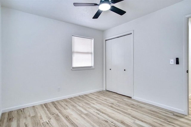 2528 Oakridge Dr, Bethany, OK 73008 - unfurnished bedroom featuring light wood-style flooring, a closet, baseboards, and ceiling fan