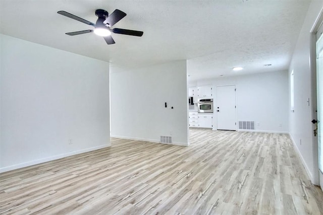 2528 Oakridge Dr, Bethany, OK 73008 - unfurnished living room featuring light wood finished floors, a ceiling fan, and baseboards