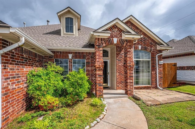 2105 SW 124th St, Oklahoma City, OK 73170 - view of front facade featuring roof with shingles, brick siding, and fence