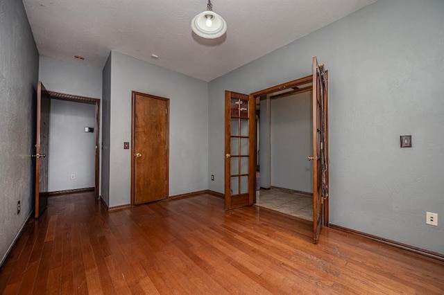 2105 SW 124th St, Oklahoma City, OK 73170 - unfurnished bedroom featuring hardwood / wood-style flooring, french doors, and baseboards