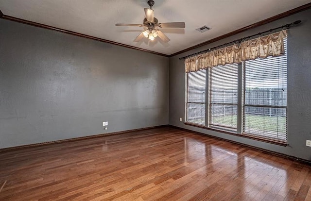 2105 SW 124th St, Oklahoma City, OK 73170 - spare room with ornamental molding, wood finished floors, ceiling fan, and baseboards
