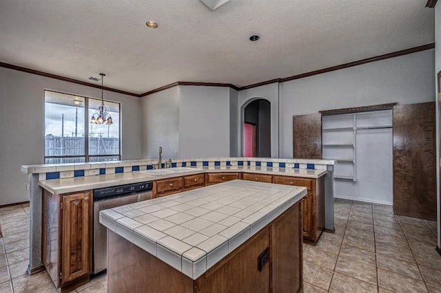 2105 SW 124th St, Oklahoma City, OK 73170 - kitchen with a kitchen island, a sink, dishwasher, tile countertops, and crown molding