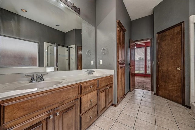 2105 SW 124th St, Oklahoma City, OK 73170 - full bath featuring tile patterned floors, a stall shower, and double vanity