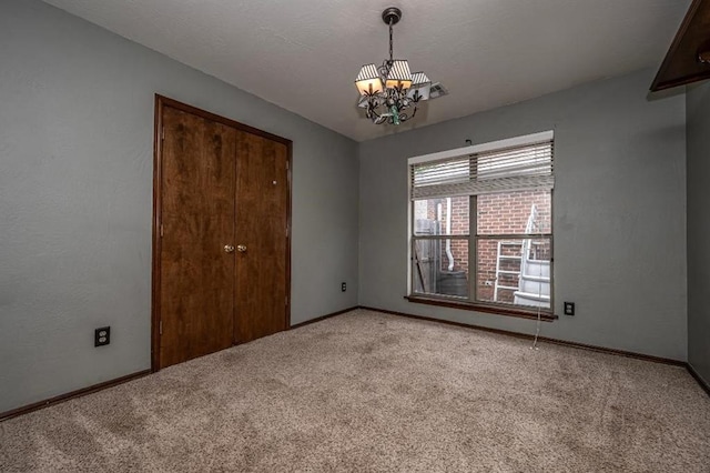 2105 SW 124th St, Oklahoma City, OK 73170 - spare room with light colored carpet, a chandelier, and baseboards