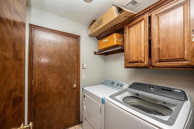 2105 SW 124th St, Oklahoma City, OK 73170 - clothes washing area with washer and clothes dryer, cabinet space, and light tile patterned floors