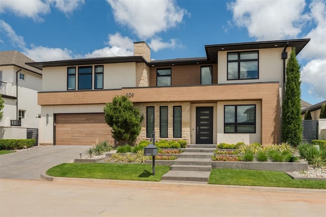 909 NW 156th St, Edmond, OK 73013 - view of front facade featuring stucco siding, concrete driveway, a garage, a chimney, and stone siding