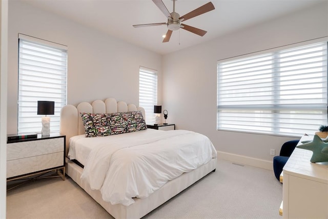 909 NW 156th St, Edmond, OK 73013 - bedroom with light carpet, baseboards, and ceiling fan