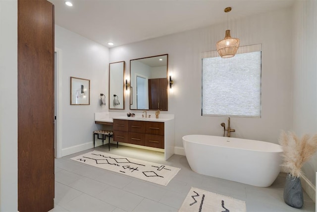 909 NW 156th St, Edmond, OK 73013 - full bathroom with a freestanding tub, vanity, tile patterned floors, recessed lighting, and baseboards