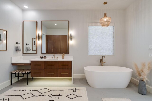 909 NW 156th St, Edmond, OK 73013 - full bathroom with baseboards, vanity, and a freestanding bath