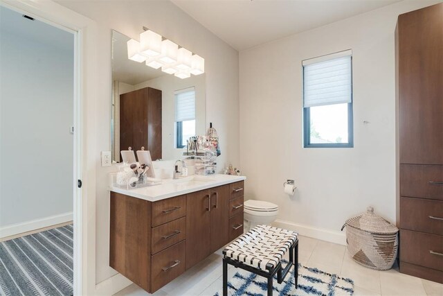 909 NW 156th St, Edmond, OK 73013 - bathroom with toilet, vanity, baseboards, and tile patterned flooring