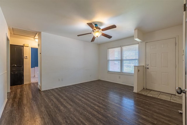 unfurnished room featuring wood finished floors, a ceiling fan, and baseboards
