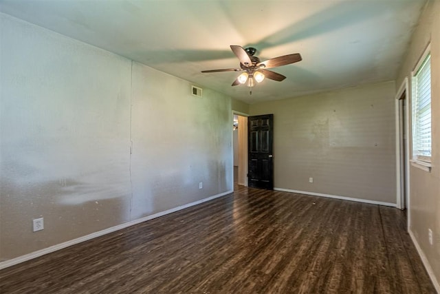 empty room featuring wood finished floors, ceiling fan, and baseboards