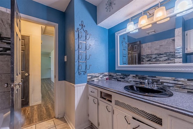 bathroom featuring a wainscoted wall, vanity, and tile patterned flooring