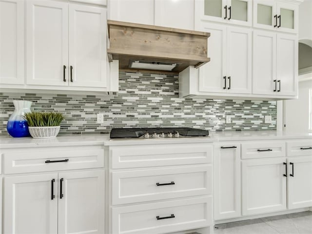 4850 Ranchero Dr, Edmond, OK 73025 - kitchen featuring stainless steel gas stovetop, ventilation hood, light countertops, and white cabinetry