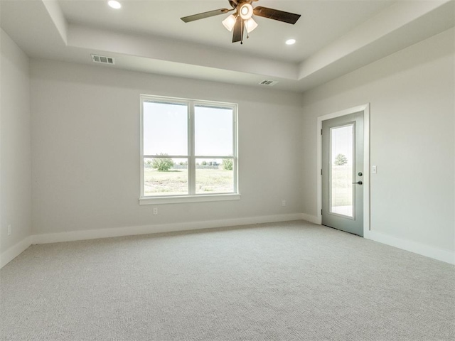 4850 Ranchero Dr, Edmond, OK 73025 - unfurnished room with a raised ceiling, ceiling fan, light colored carpet, baseboards, and recessed lighting