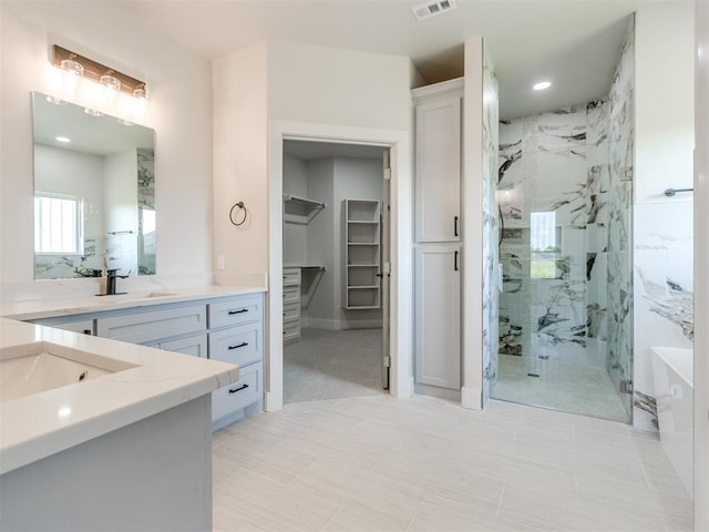 4850 Ranchero Dr, Edmond, OK 73025 - bathroom with a marble finish shower, vanity, a spacious closet, and recessed lighting