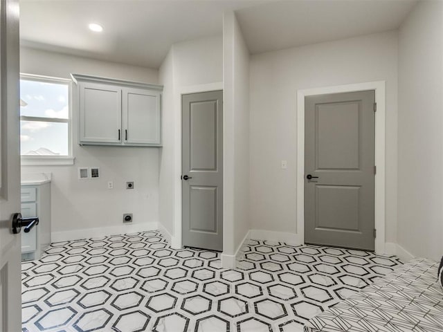 4850 Ranchero Dr, Edmond, OK 73025 - laundry area featuring hookup for an electric dryer, washer hookup, cabinet space, and baseboards