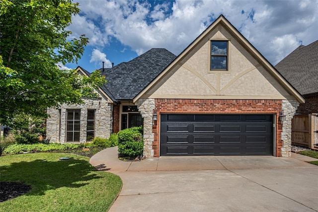 view of front facade with driveway, stone siding, a front lawn, stucco siding, and brick siding
