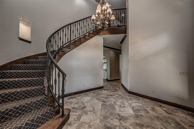 stairs with a chandelier, baseboards, and a towering ceiling