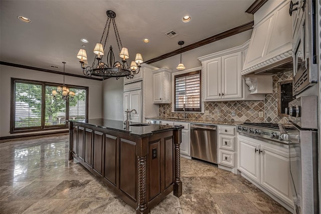 kitchen featuring appliances with stainless steel finishes, a chandelier, crown molding, a sink, and backsplash