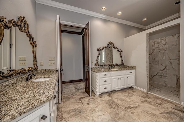 bathroom featuring ornamental molding, two vanities, a tile shower, recessed lighting, and baseboards