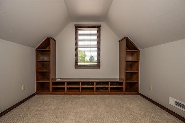 bonus room with lofted ceiling, carpet floors, and baseboards