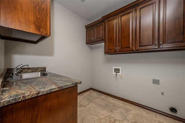 laundry area featuring cabinet space, baseboards, hookup for a washing machine, and light stone finish floors