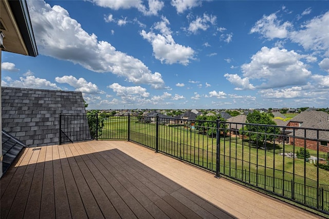wooden terrace featuring a residential view and a yard
