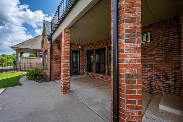 view of patio / terrace featuring fence