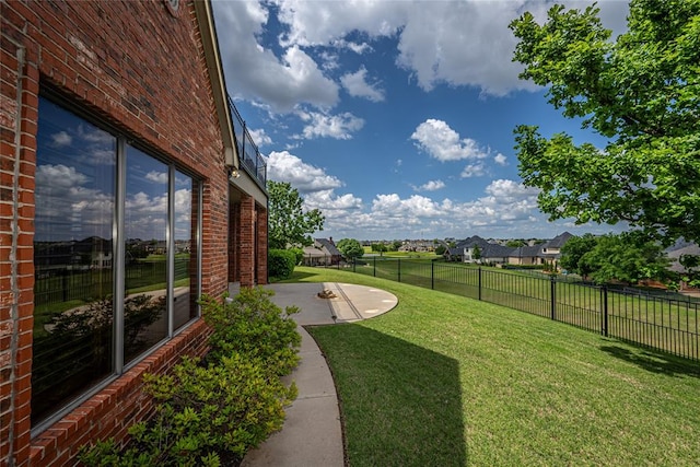 view of yard featuring a patio and a residential view