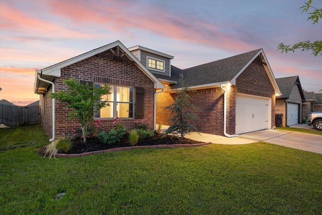 9117 NW 123rd St, Yukon, OK 73099 - traditional home featuring brick siding, a garage, driveway, and roof with shingles