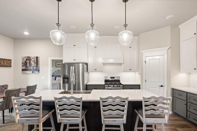 9117 NW 123rd St, Yukon, OK 73099 - kitchen featuring appliances with stainless steel finishes, tasteful backsplash, light countertops, and custom range hood