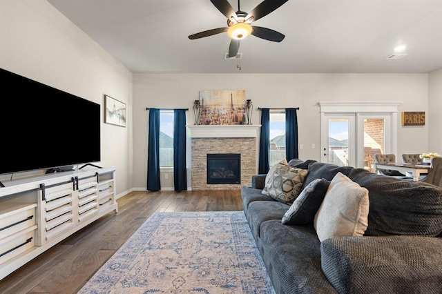9117 NW 123rd St, Yukon, OK 73099 - living room featuring dark wood-style flooring, ceiling fan, baseboards, and a fireplace