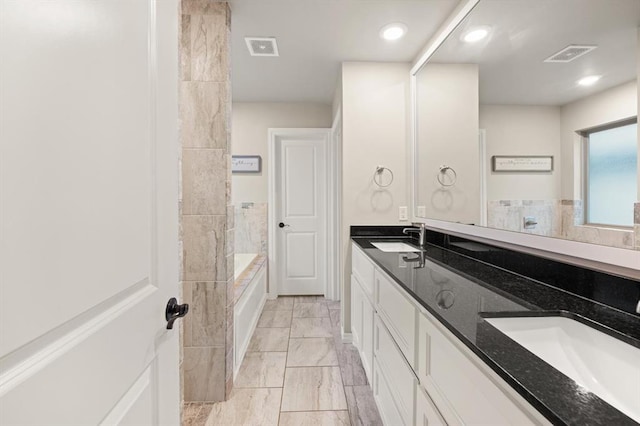 9117 NW 123rd St, Yukon, OK 73099 - bathroom with double vanity, marble finish flooring, a tub to relax in, and recessed lighting