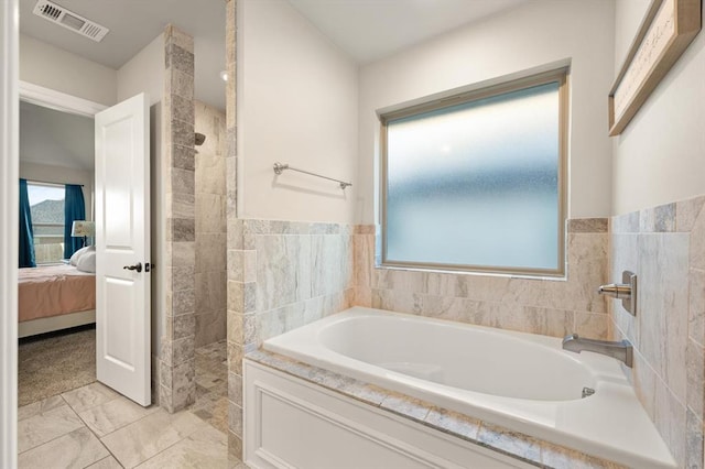 9117 NW 123rd St, Yukon, OK 73099 - bathroom with connected bathroom, tiled shower, and a garden tub